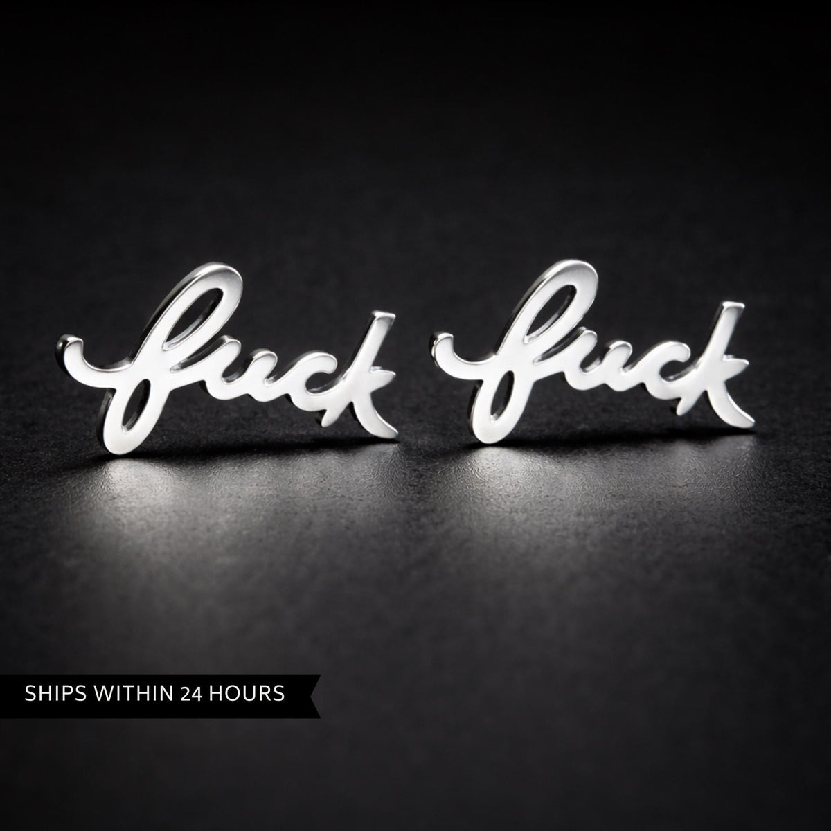Close-up of cursive Fuck stud earrings in polished silver stainless steel