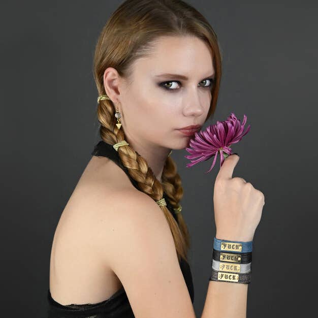 fuck bracelet with rebellious woman smelling flower, rebel attitude, motorcycle, confident, strong woman