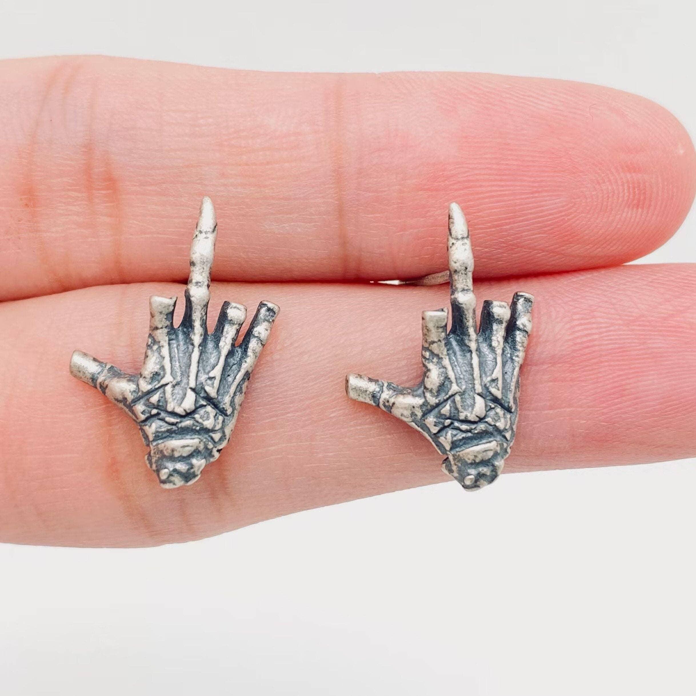 sterling silver skeleton skull hand stud earrings hypoallergenic fuck you flipping off funny sassy profanity high quality free shipping playful unique traditional jewelry intricate detailing edgy skull bones bold touch make a statement individuality hypoallergenic sterling silver high quality handmade punk gothic jewelry rebellious accessories alternative fashion statement earrings bold jewelry unique earrings sterling silver earrings sassy stud earrings bold statement jewelry