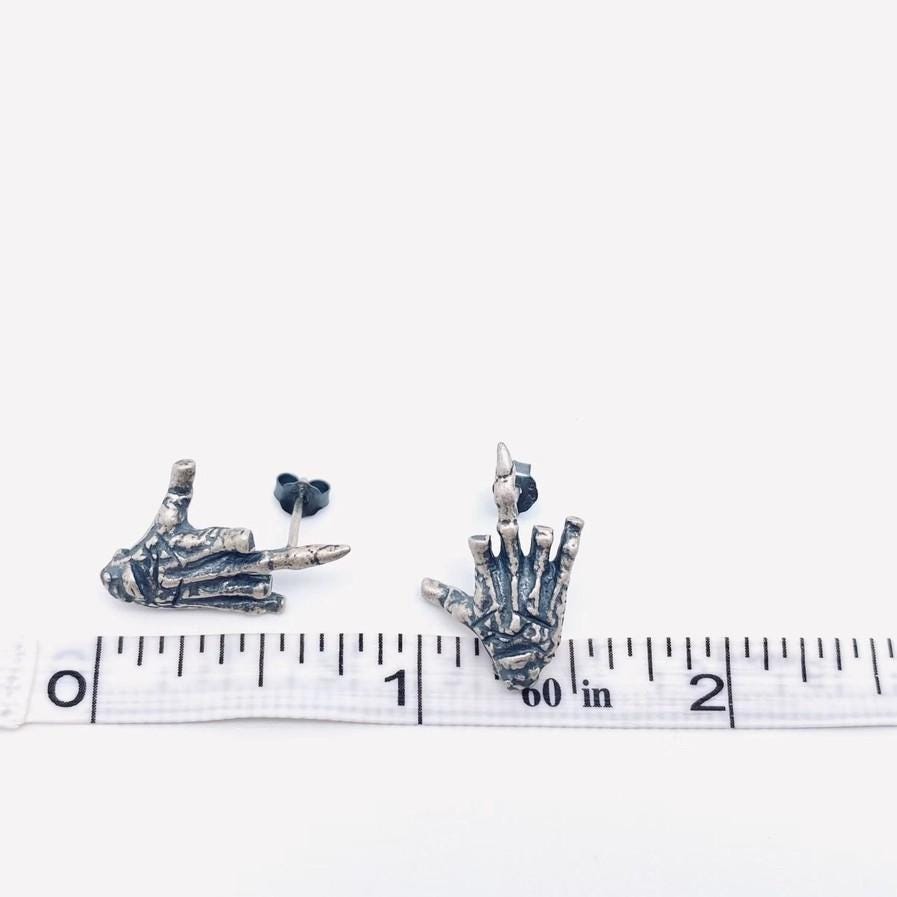 sterling silver skeleton skull hand stud earrings hypoallergenic fuck you flipping off funny sassy profanity high quality free shipping playful unique traditional jewelry intricate detailing edgy skull bones bold touch make a statement individuality hypoallergenic sterling silver high quality handmade punk gothic jewelry rebellious accessories alternative fashion statement earrings bold jewelry unique earrings sterling silver earrings sassy stud earrings bold statement jewelry